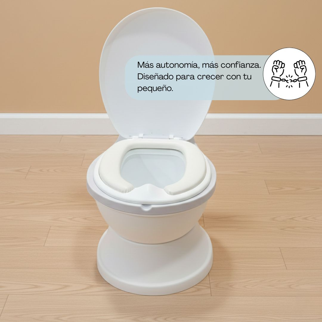 Asiento de orinal infantil blanco con aro acolchado sobre suelo de madera.