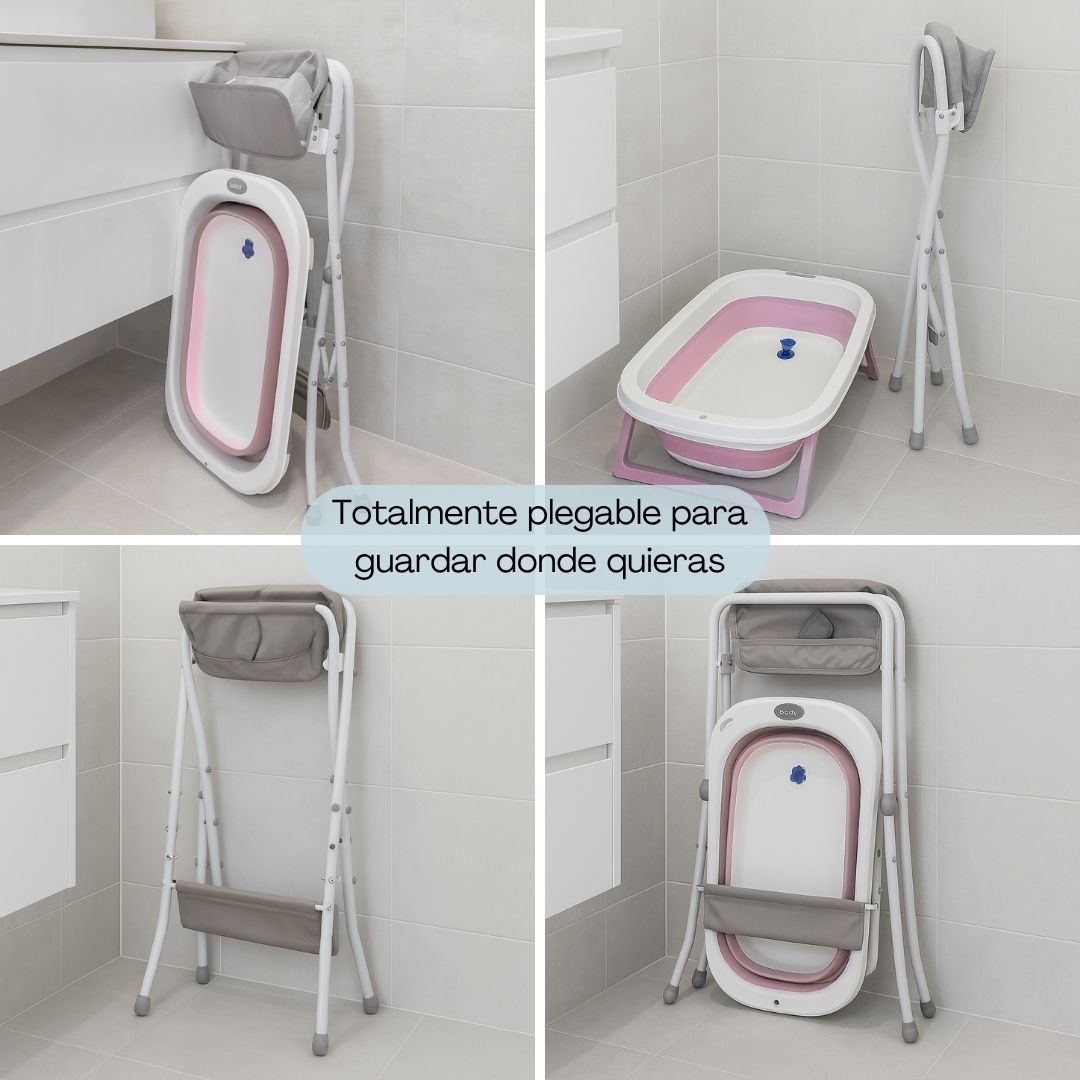 Un soporte plegable para bañera de bebé con bolsa gris, marco blanco y bañera rosa.