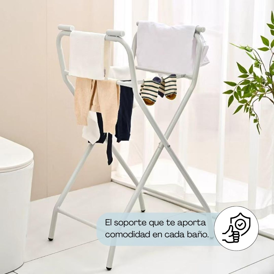 Un tendedero blanco con ropa y calcetines, junto a un bidé.