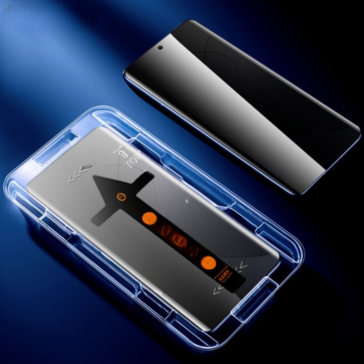 Una protezione per lo schermo dello smartphone in un supporto blu, accanto a uno smartphone nero.