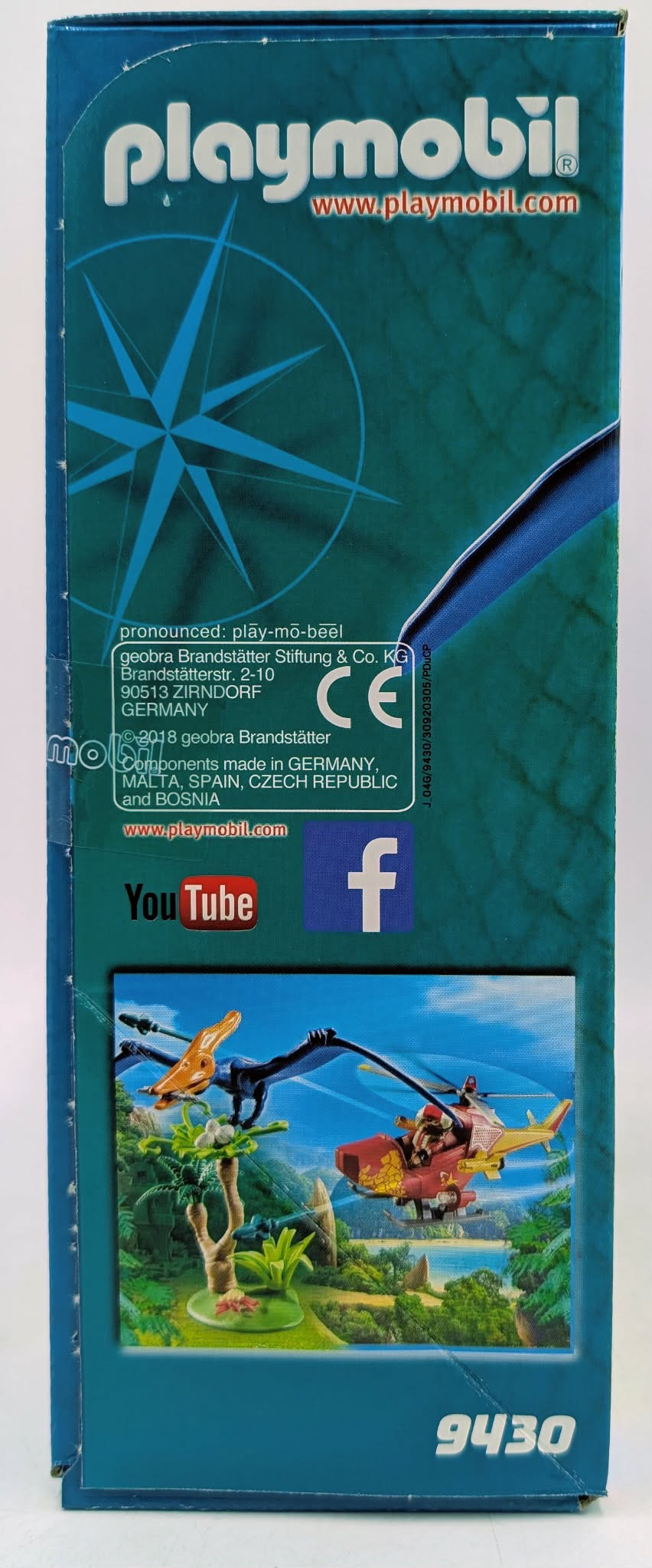 Playmobil packaging showing a toy jungle scene with a helicopter and dinosaurs.