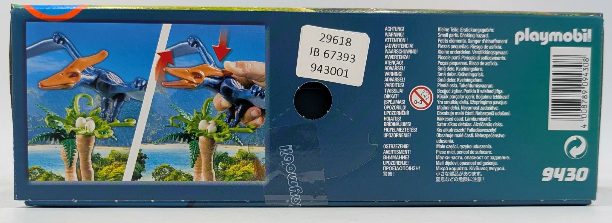 Playmobil box with a blue pterodactyl toy, two palm trees, and warning labels in multiple languages.