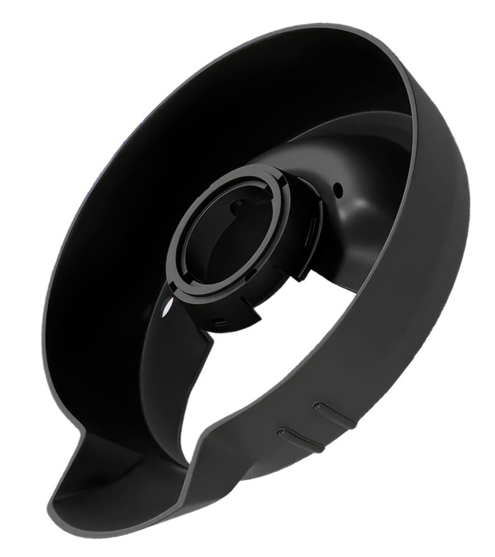 Un componente negro y circular con anillos interiores y una abertura ancha.
