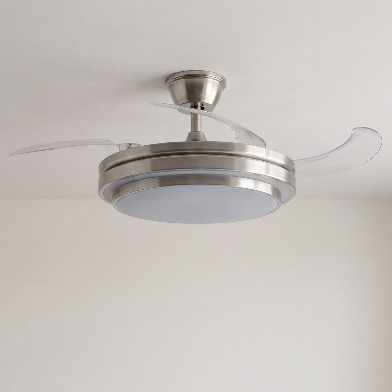 Un ventilador de techo moderno con aspas retráctiles y luz integrada.