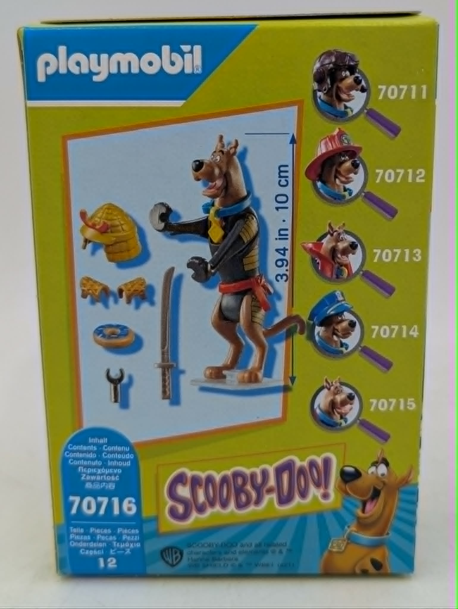 Pudełko Playmobil Scooby-Doo z figurką, akcesoriami i różnymi strojami.
