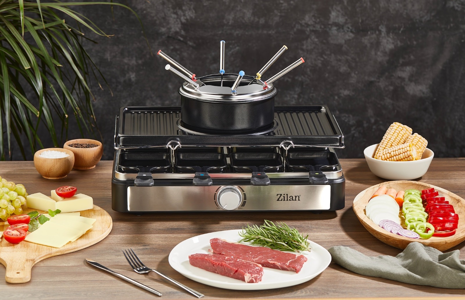 Et, peynir, sebze ve mısır koçanı gibi malzemelerle raclette ızgarası.