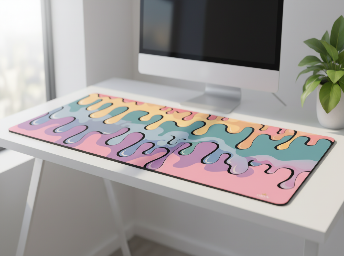 Renkli damla desenli mousepad, monitör ve bitkili masa.