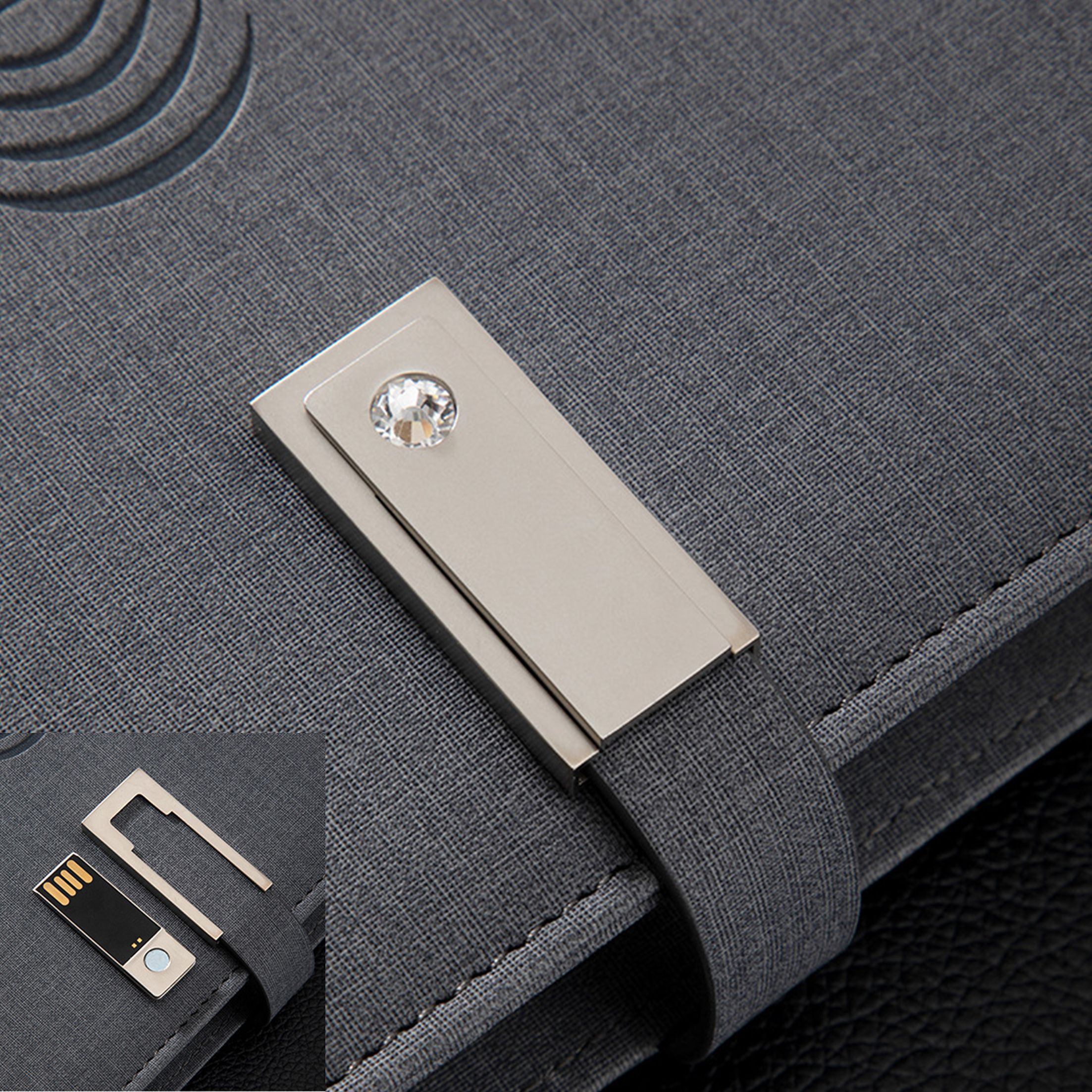 Graues Notizbuch mit silbernem Verschluss, Juwel und USB-Stick.