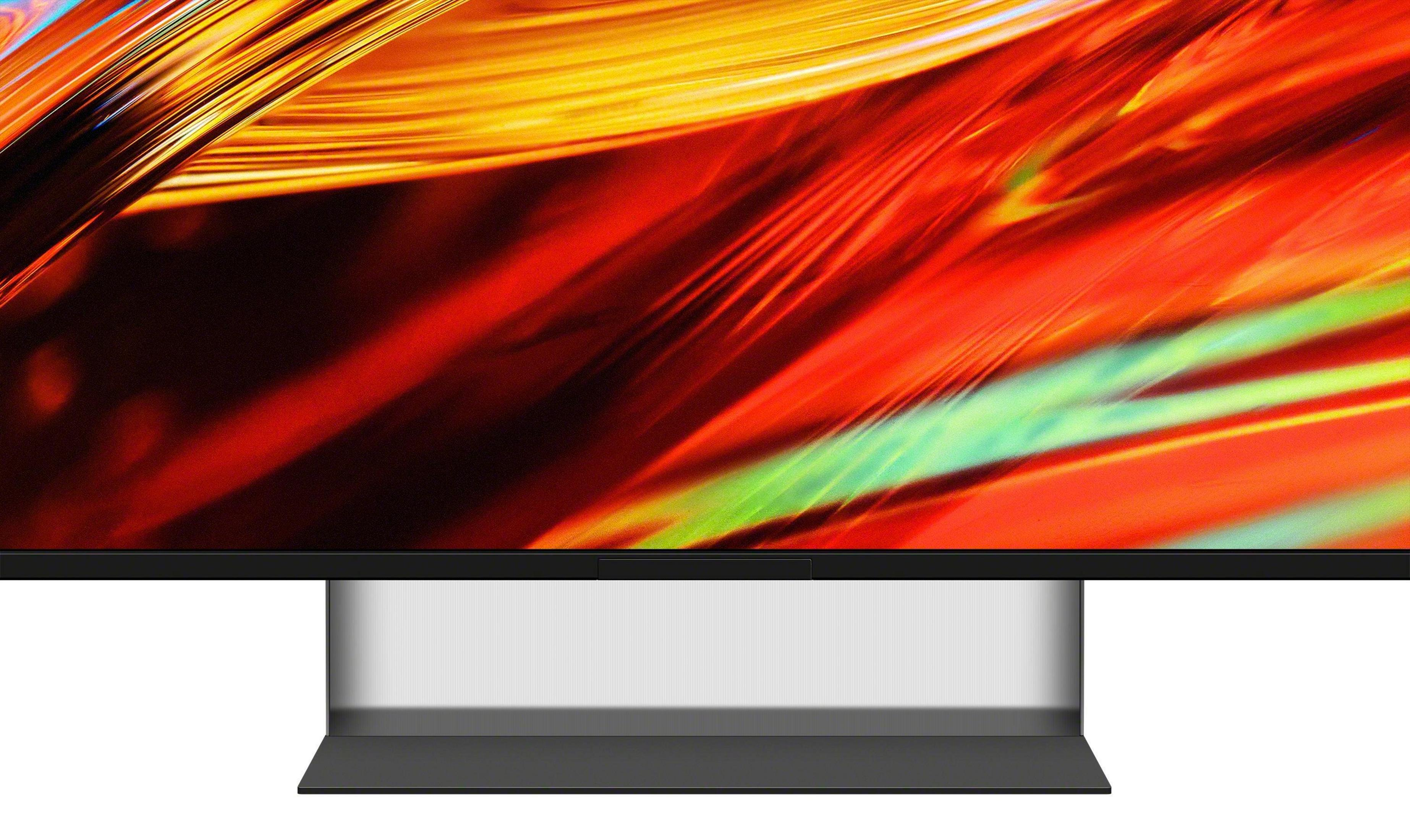 Primer plano de la parte inferior de la pantalla de un televisor con fondo abstracto rojo y amarillo.