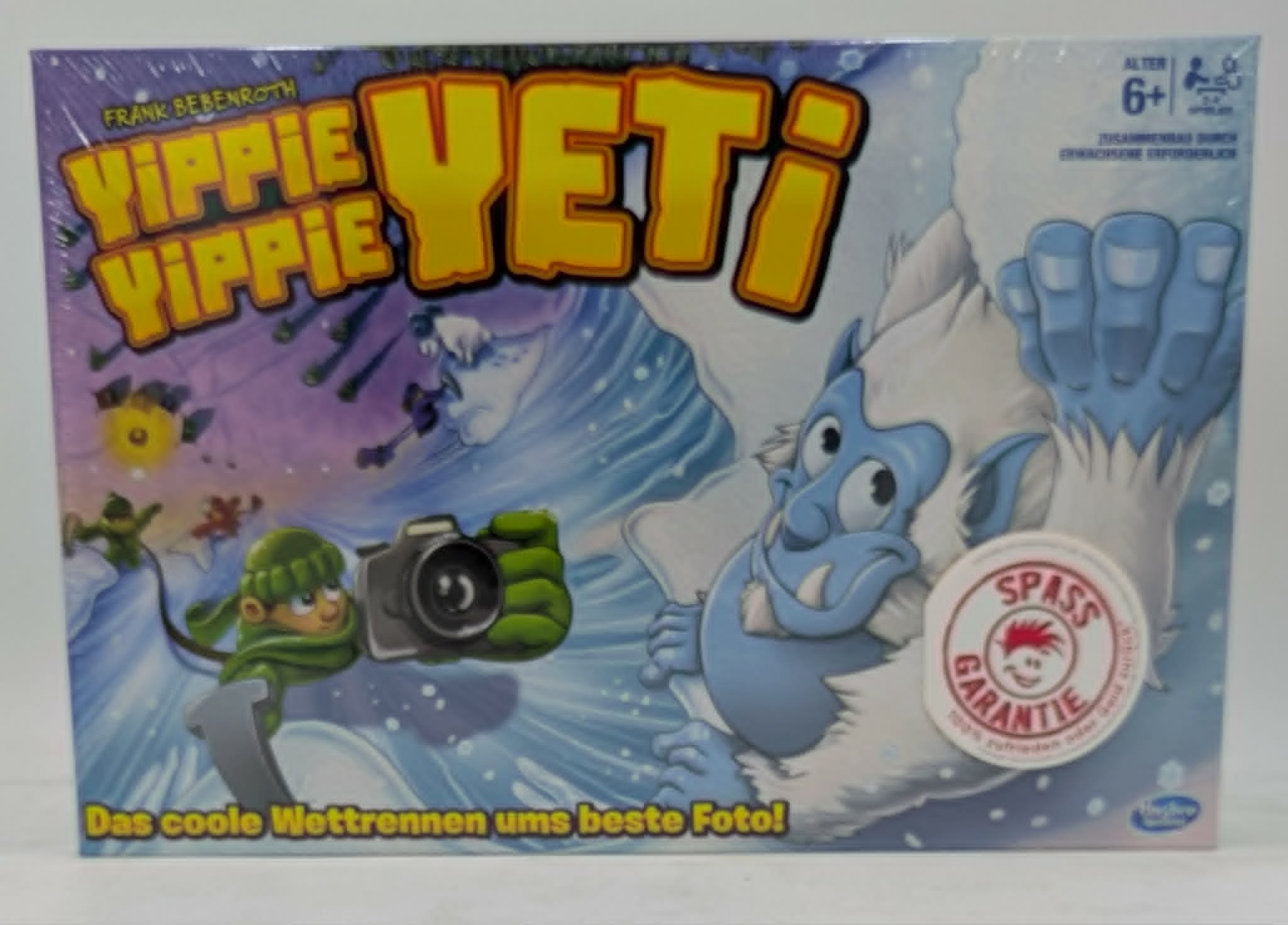 Brettspiel "Yippie Yippie Yeti" mit Yeti und Fotograf, für Spieler ab 6 Jahren.