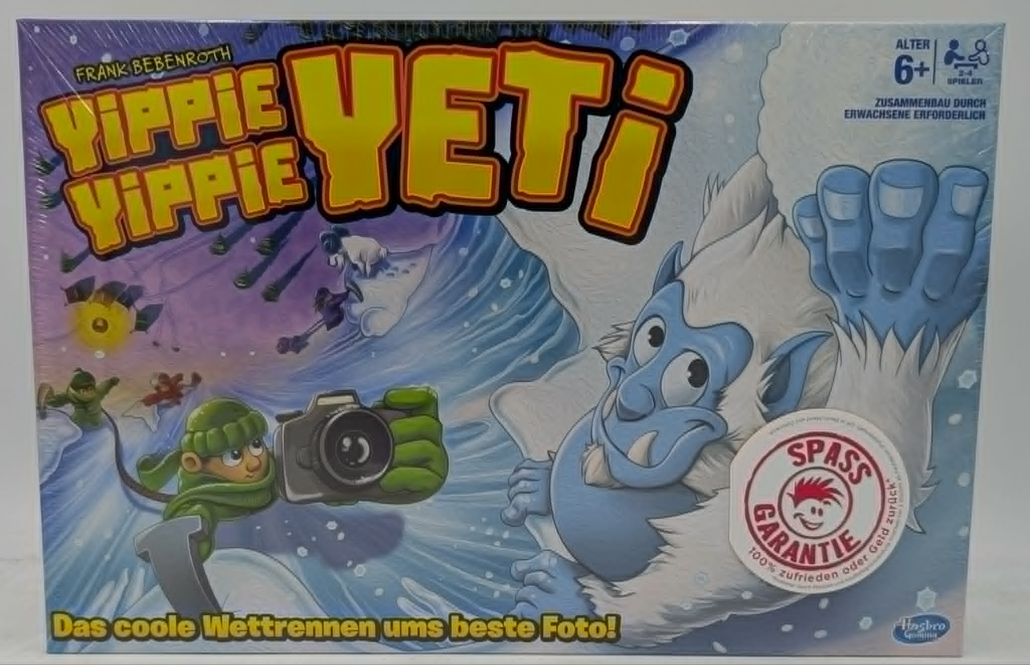 Brettspiel "Yippie Yippie Yeti" mit Yeti, Fotograf und Schneeflocken.