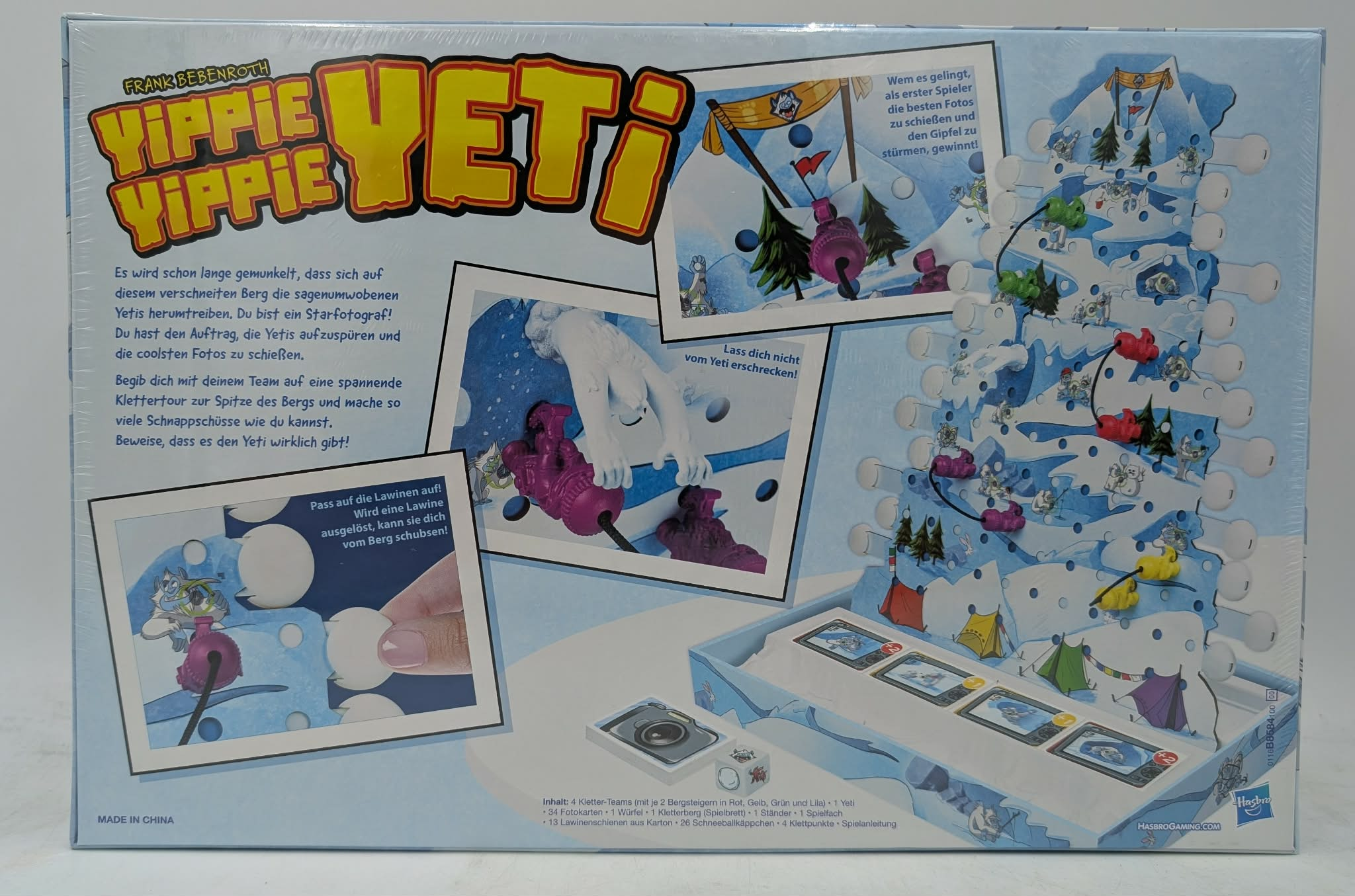 Brettspielverpackung mit Berg, Yetis, Bergsteigern und Spielanleitung.