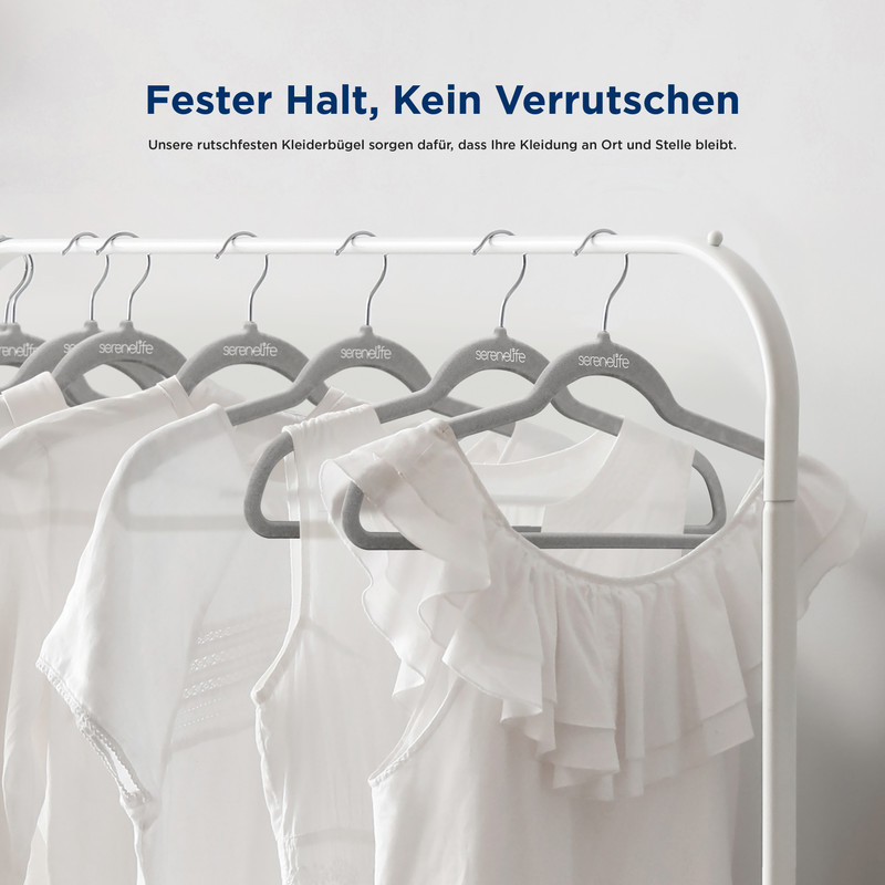 Weiße Kleidungsstücke hängen an grauen Kleiderbügeln an einer Kleiderstange.