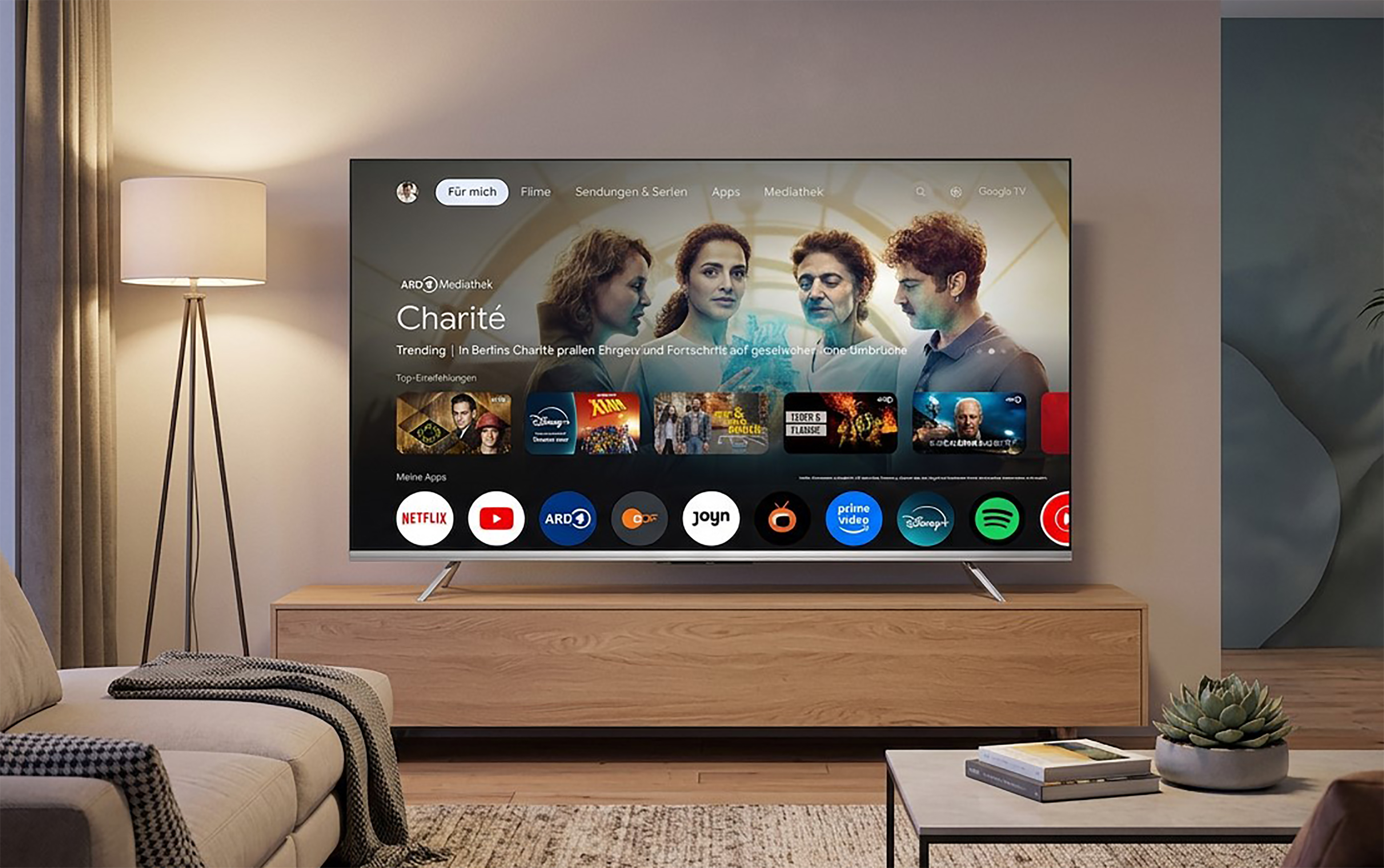Ein moderner Fernseher zeigt die Benutzeroberfläche von Google TV mit verschiedenen Apps und Inhalten.