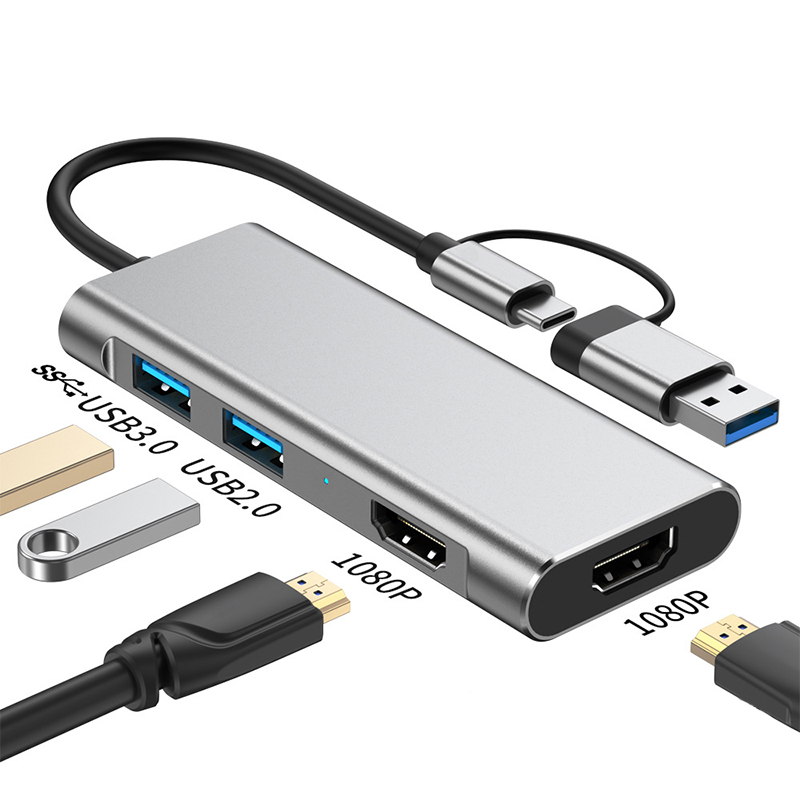 Silberne USB-C-Dockingstation mit USB-A-, USB-C- und HDMI-Anschlüssen. Inklusive USB-Sticks und HDMI-Kabeln.