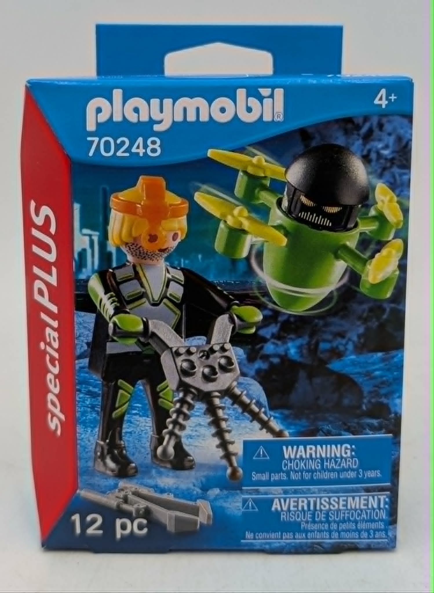 Scatola Playmobil Special Plus set 70248, con un personaggio con casco arancione su un veicolo grigio e un drone verde.