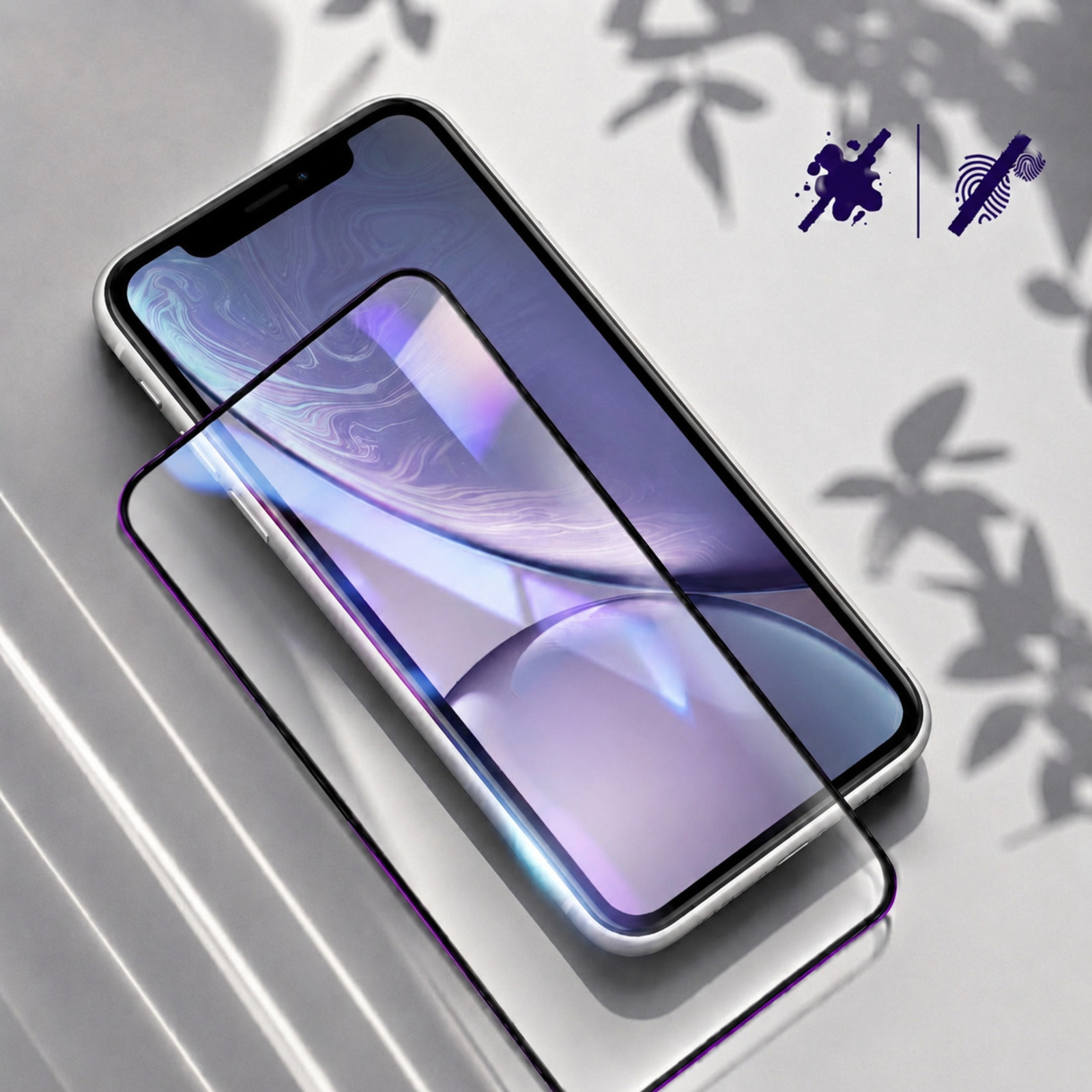 Smartfon z osłoną ekranu. Widoczne cienie liści na tle.