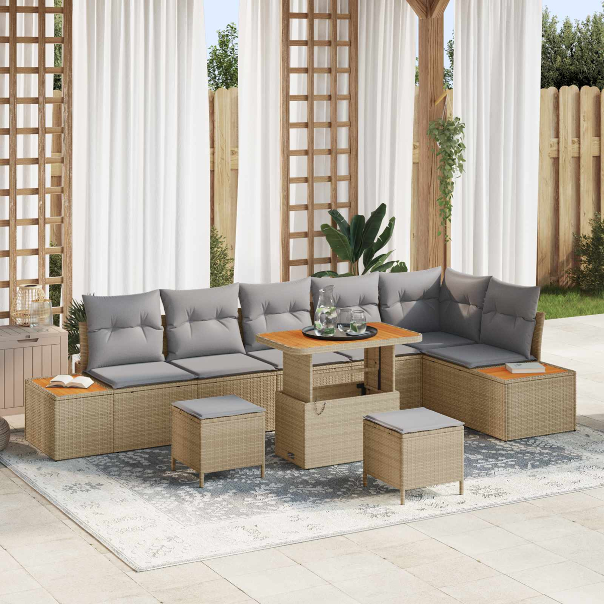 Ein beigefarbener Rattansofa-Set mit grauen Kissen und einem Couchtisch auf einem Teppich im Freien.