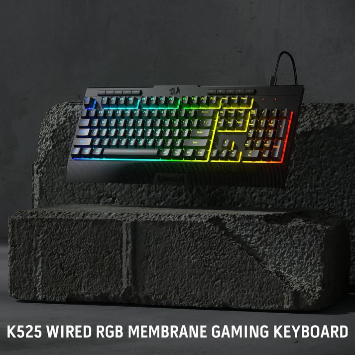 Taş blokların üzerine yerleştirilmiş RGB aydınlatmalı siyah oyuncu klavyesi.