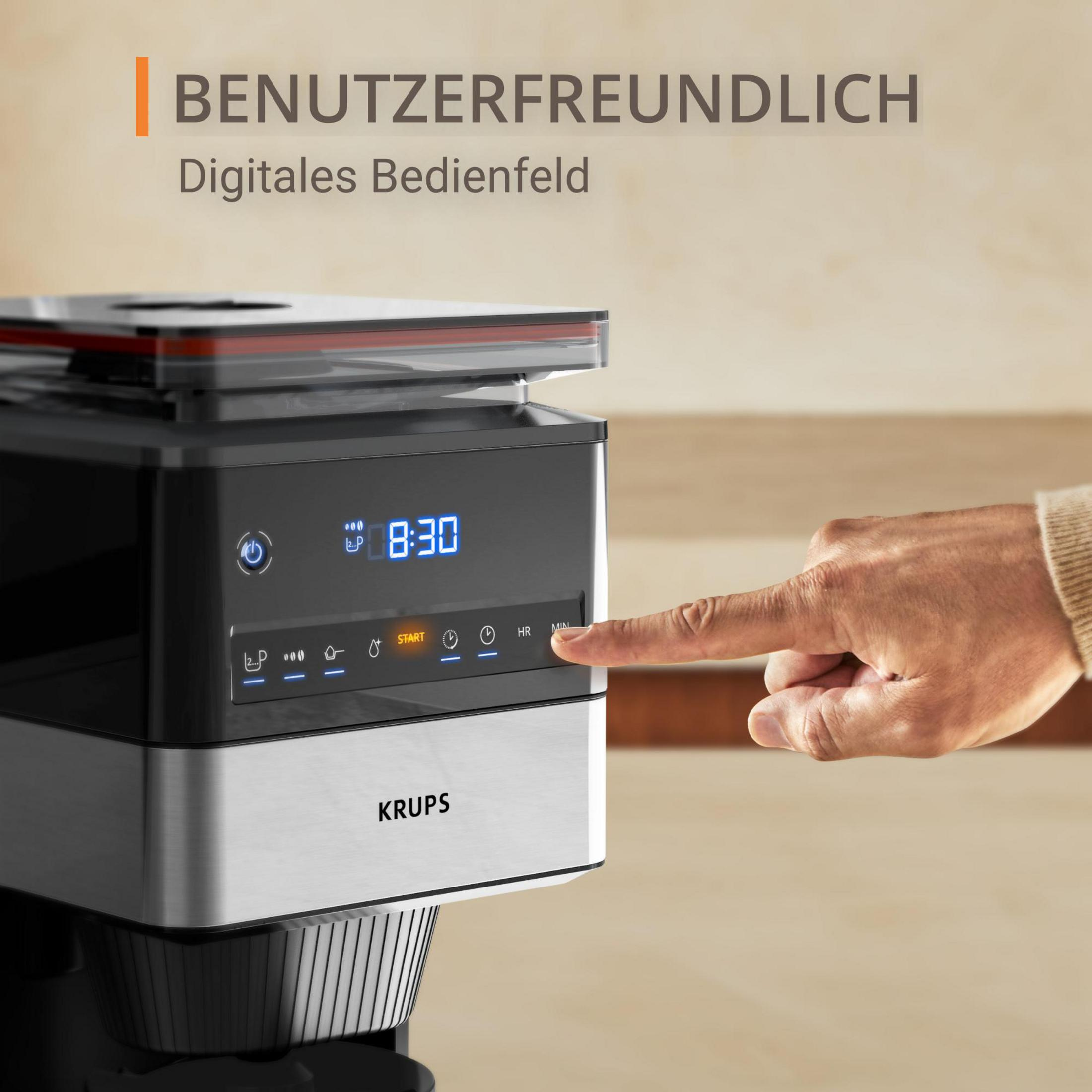 Ein Finger drückt auf die Min-Taste des digitalen Bedienfelds einer Krups Kaffeemaschine.