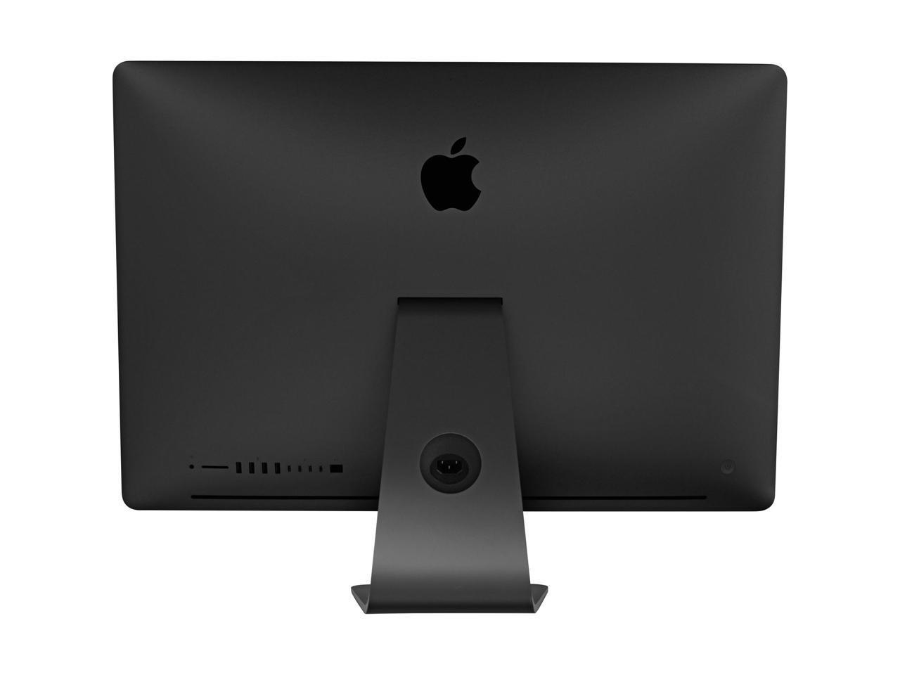 Tył czarnego komputera iMac z logo Apple i podstawką.