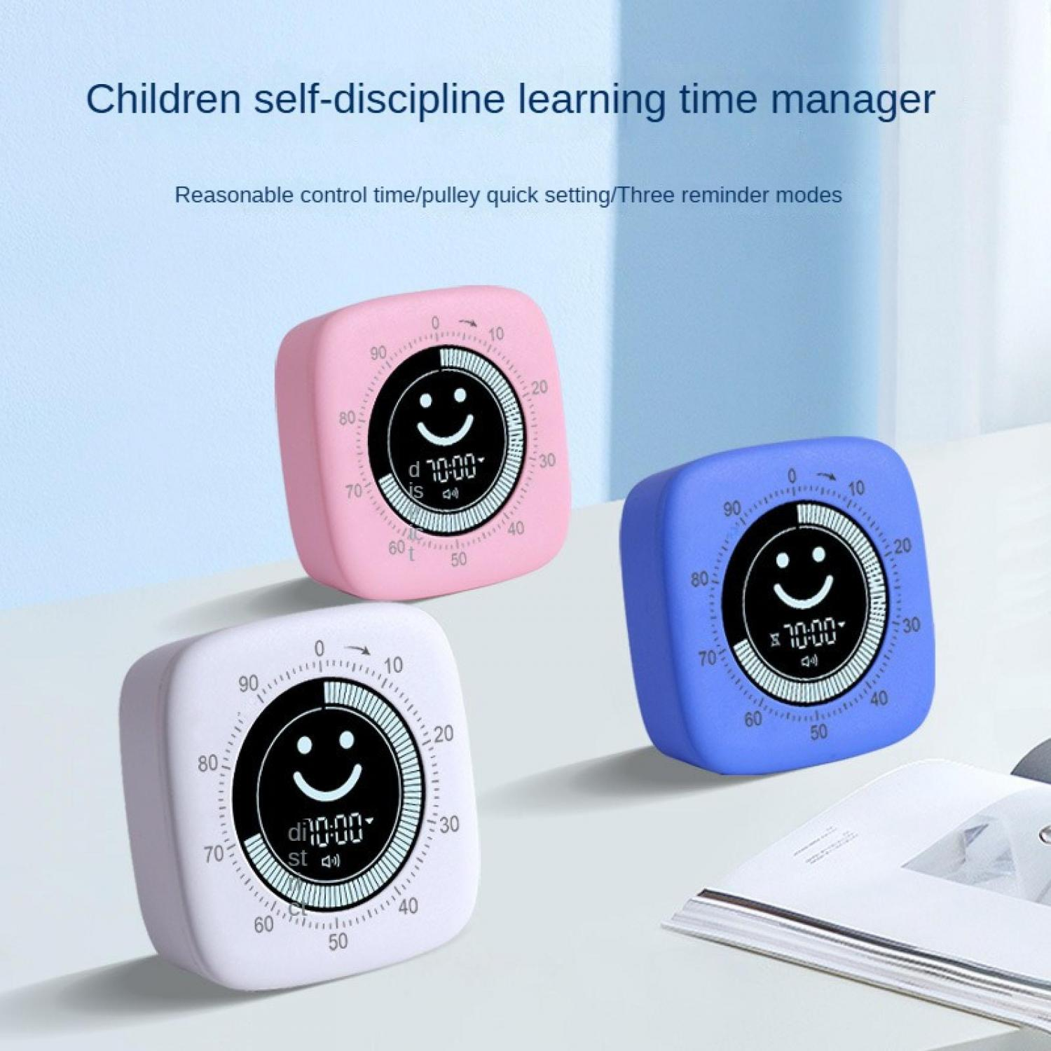 Drei bunte Timer mit Smiley-Gesicht-Anzeige auf einem Tisch.