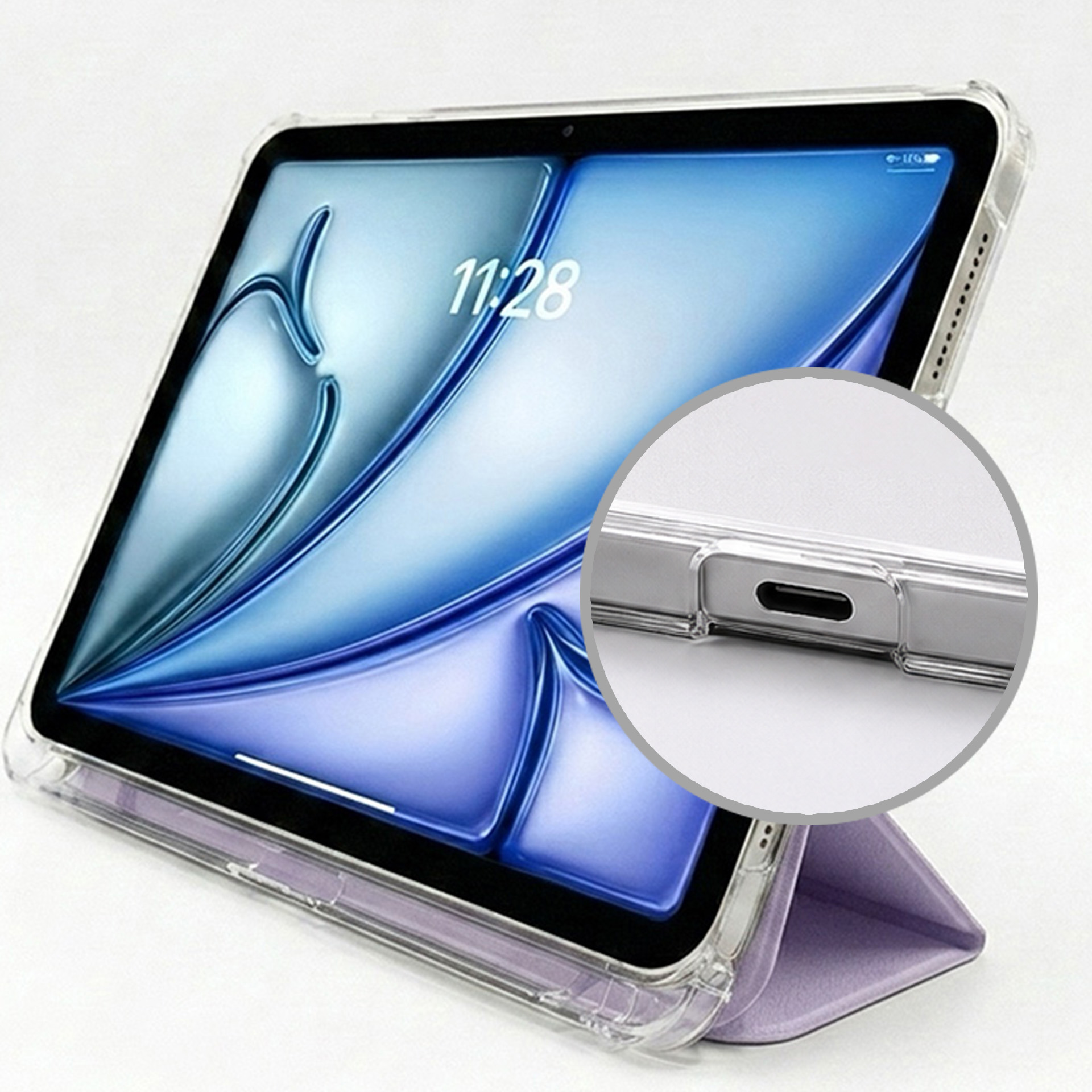 Przezroczysty tablet w fioletowej podstawce, z zbliżeniem na port ładowania.