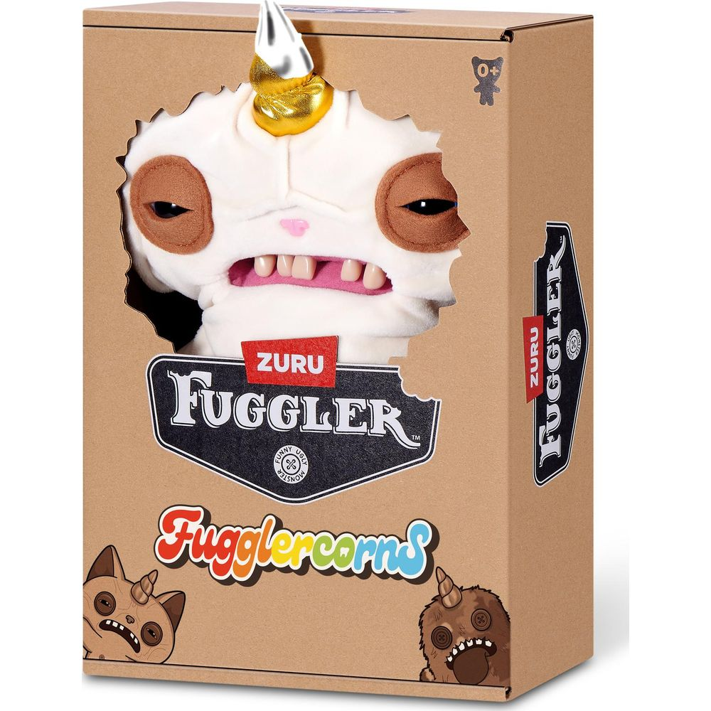 Ein weißes Plüschtier mit Einhornhorn und Zähnen in einer Pappverpackung.