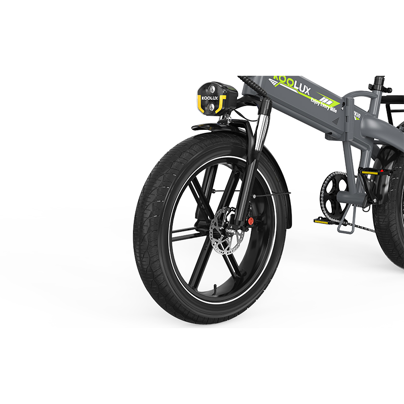 Bicicleta eléctrica gris con neumáticos anchos, faro amarillo y logo KOOLUX.