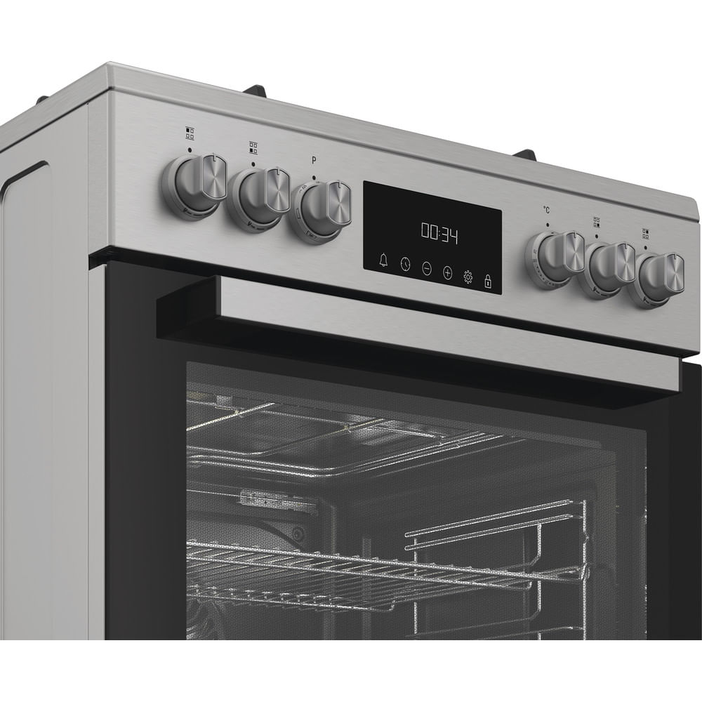 Forno argento con display digitale (00:34), manopole e griglie visibili all'interno.