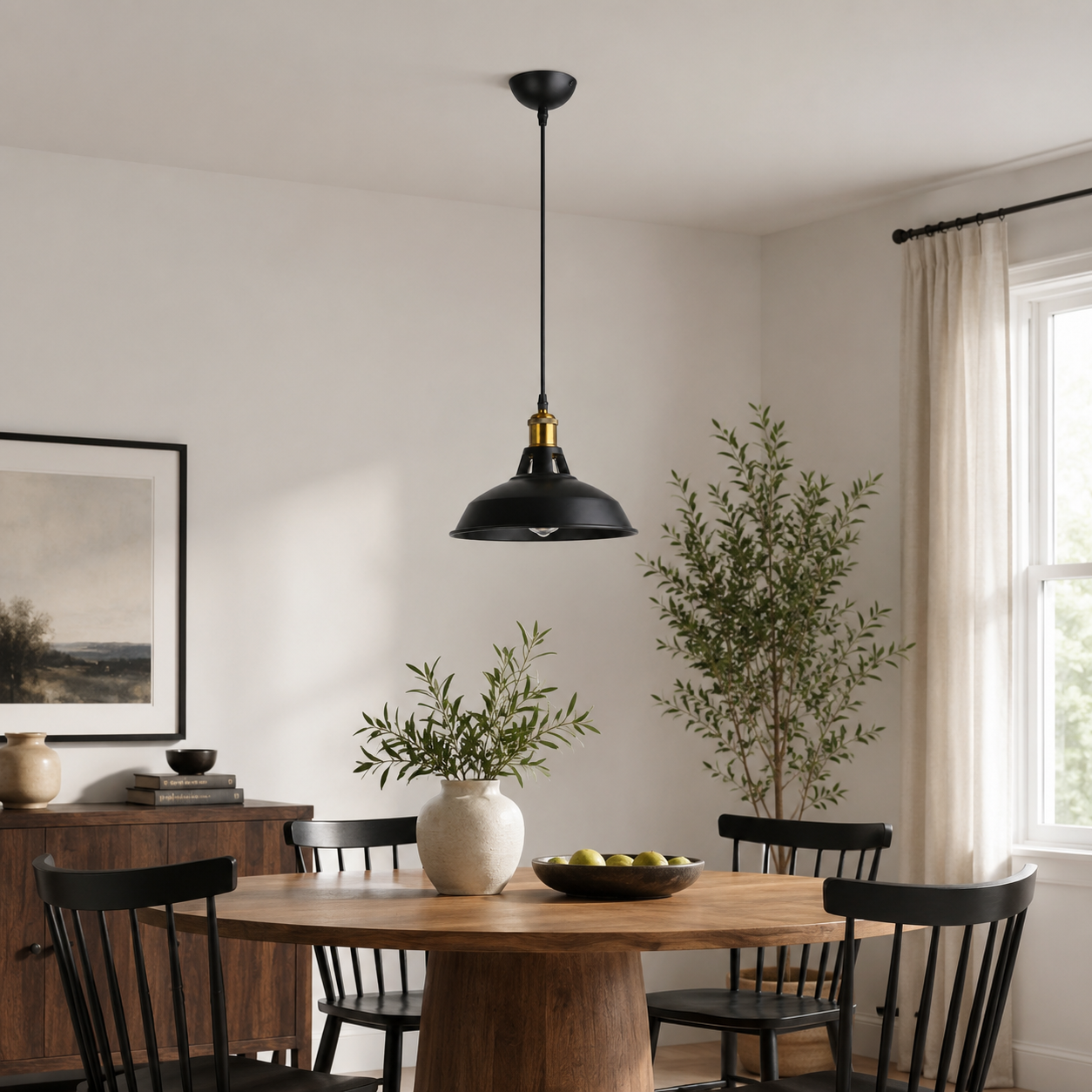 Una mesa de comedor de madera con sillas negras bajo una lámpara colgante negra.