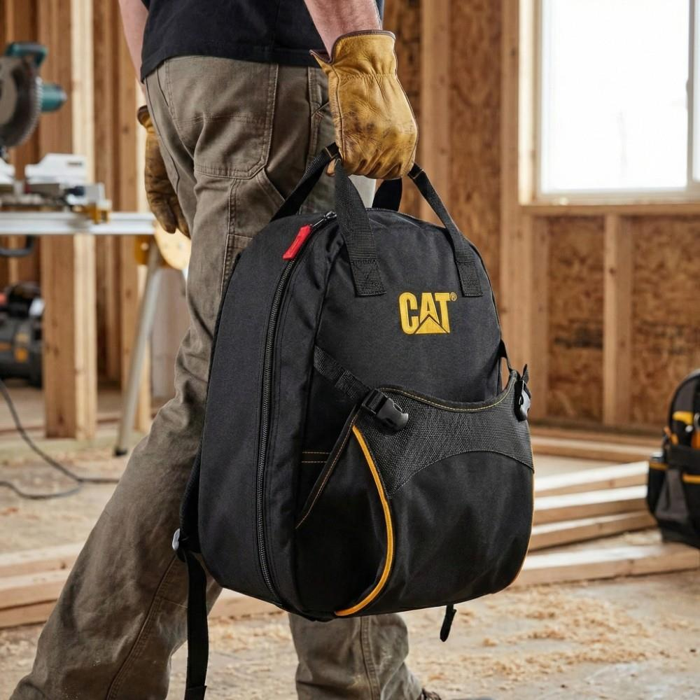 İş eldivenli bir kişi CAT logolu siyah sırt çantası taşıyor.