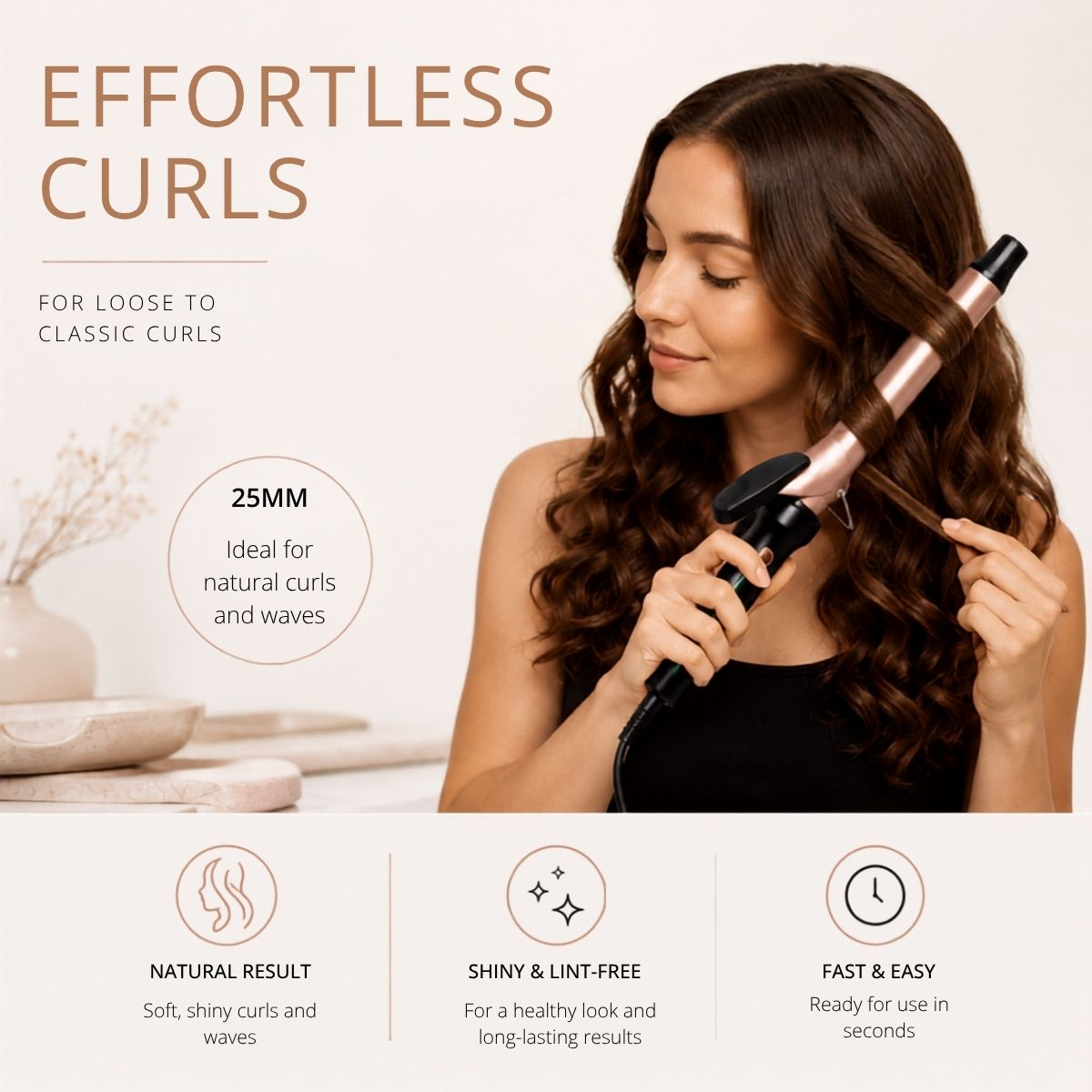A woman with brown hair styles her hair with a rose gold curling iron.
