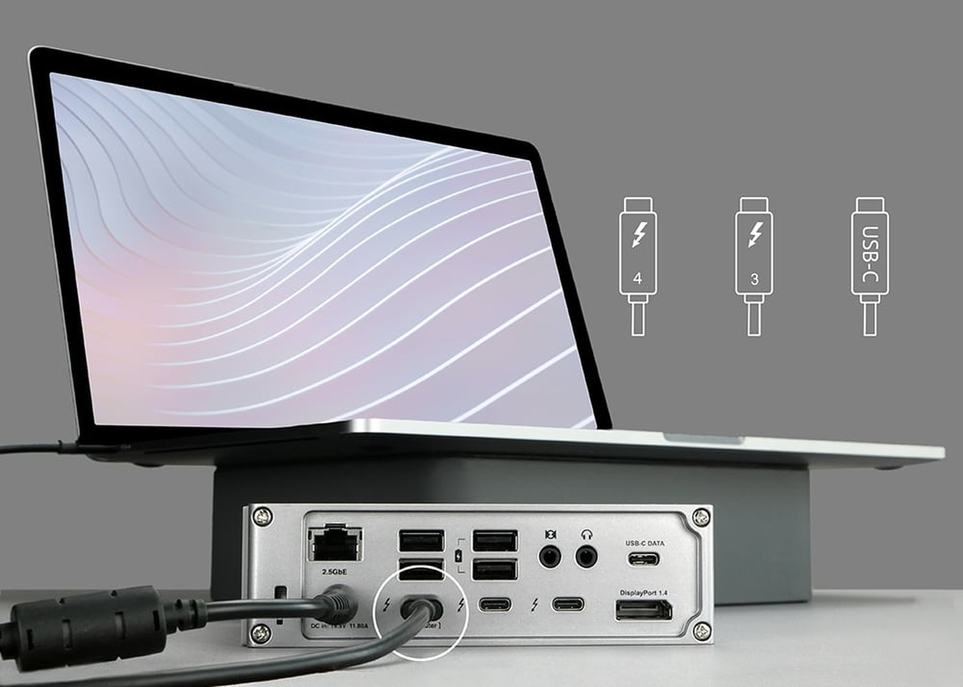 A laptop is connected to a docking station with various ports.