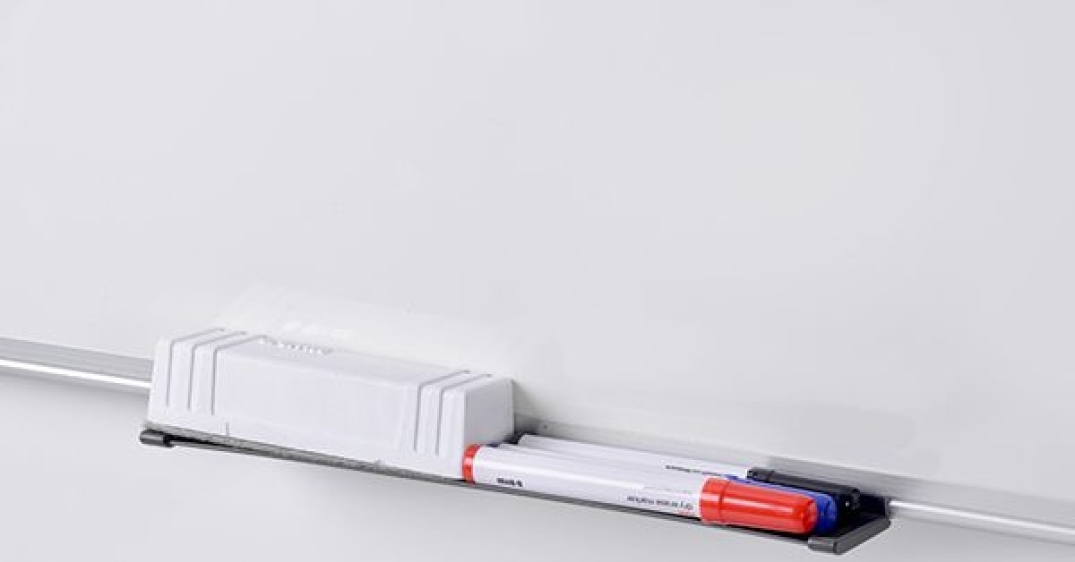 Ein weißer Whiteboard-Markerhalter mit roten und blauen Markern.