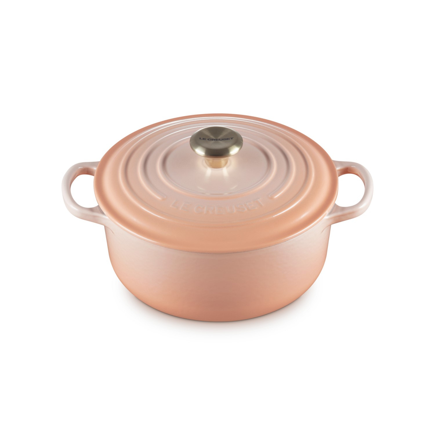 Eine rosafarbene Cocotte mit zwei Griffen und einem silbernen Knopf auf dem Deckel.