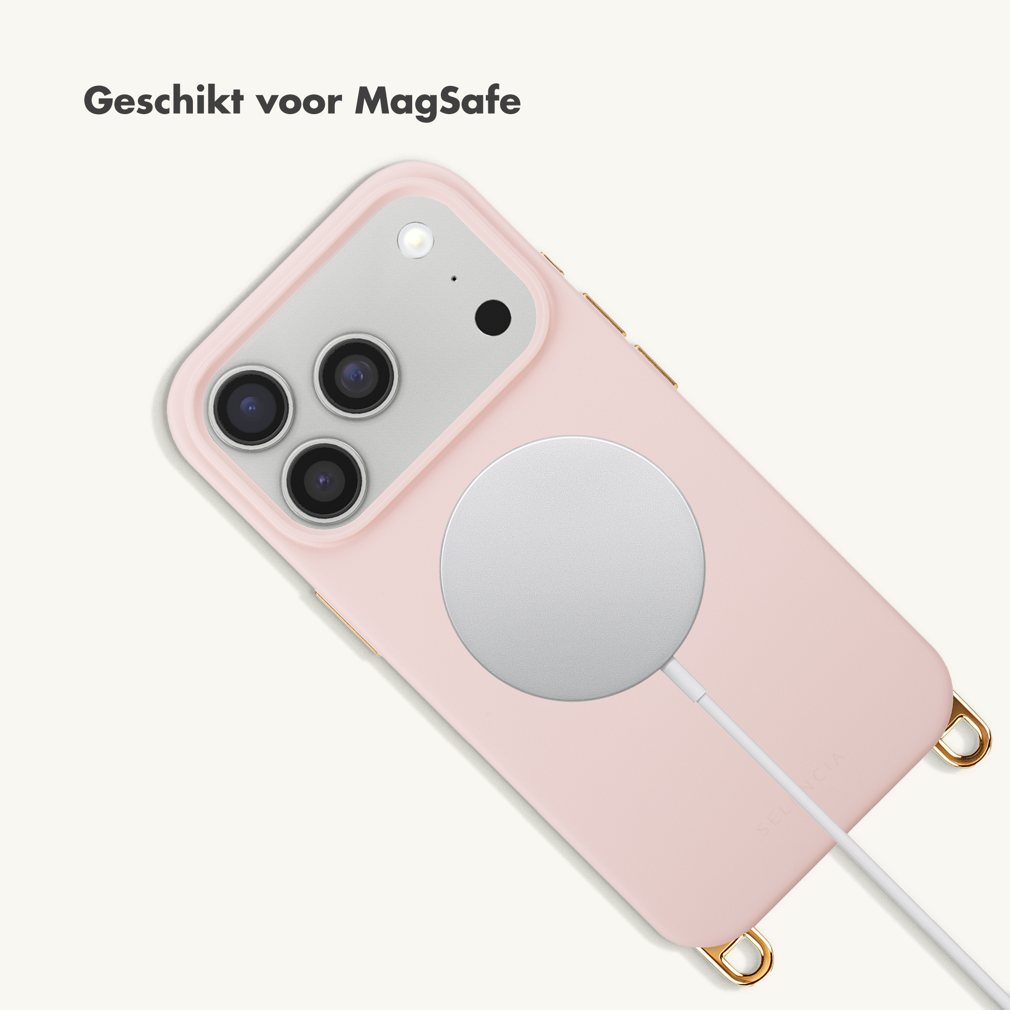 Een roze iPhone met MagSafe oplader en kabel op witte achtergrond.