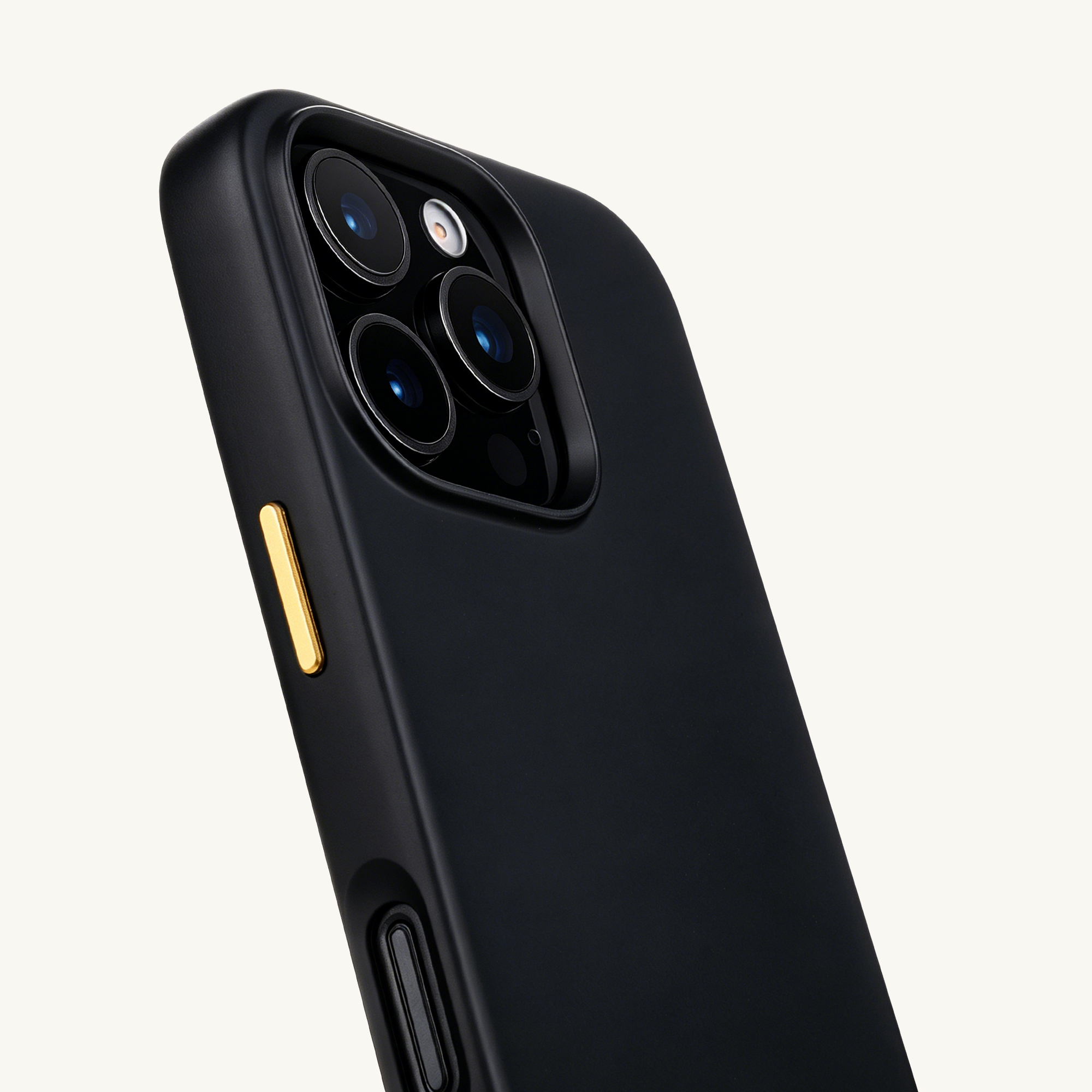 Funda negra para teléfono con tres cámaras y botón dorado, vista cercana.