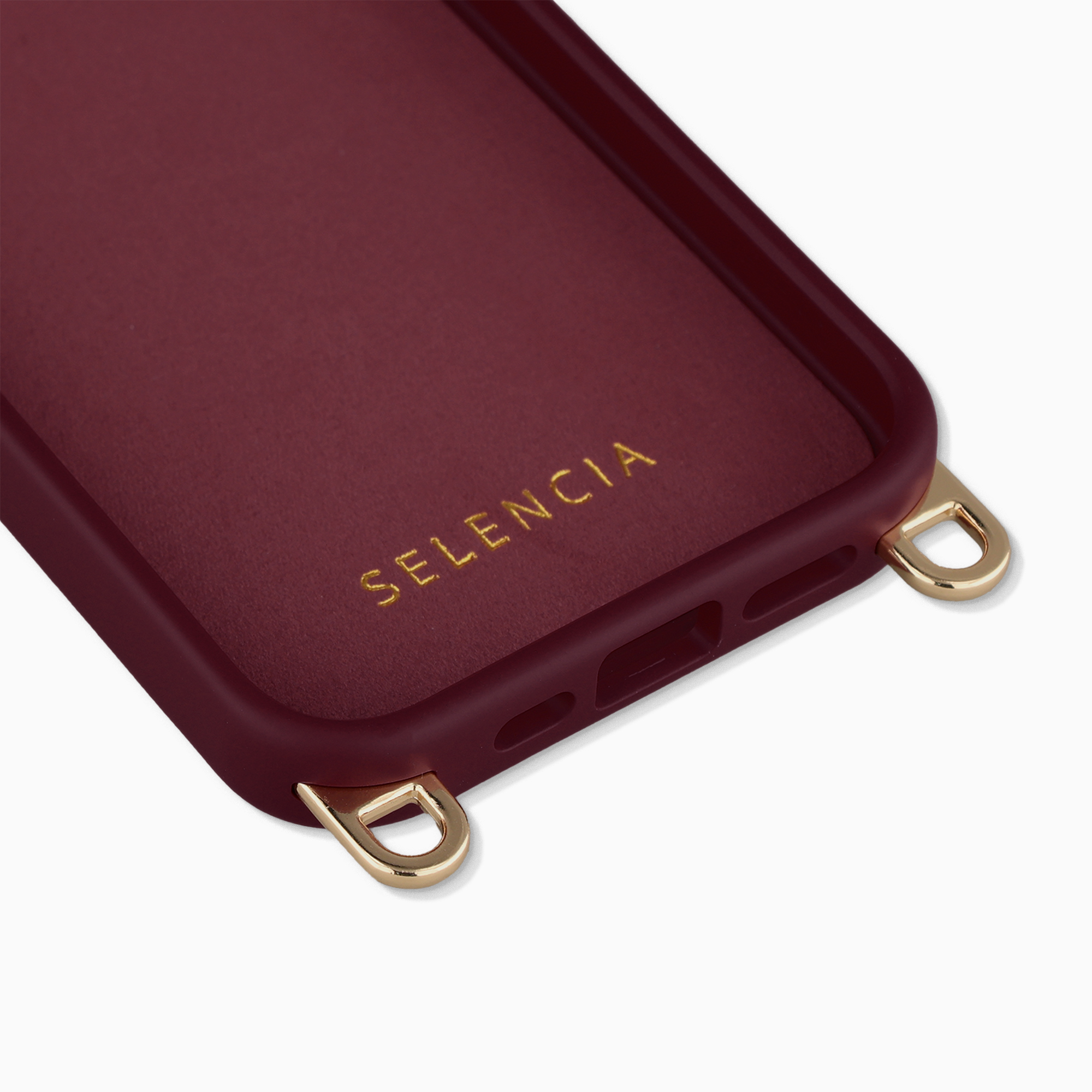 Coque de téléphone bordeaux avec œillets dorés et logo en relief.