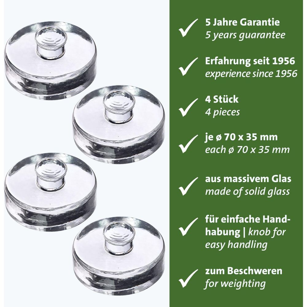 Vier runde Glasdeckel mit Griffen, nebeneinander auf weißem Hintergrund.