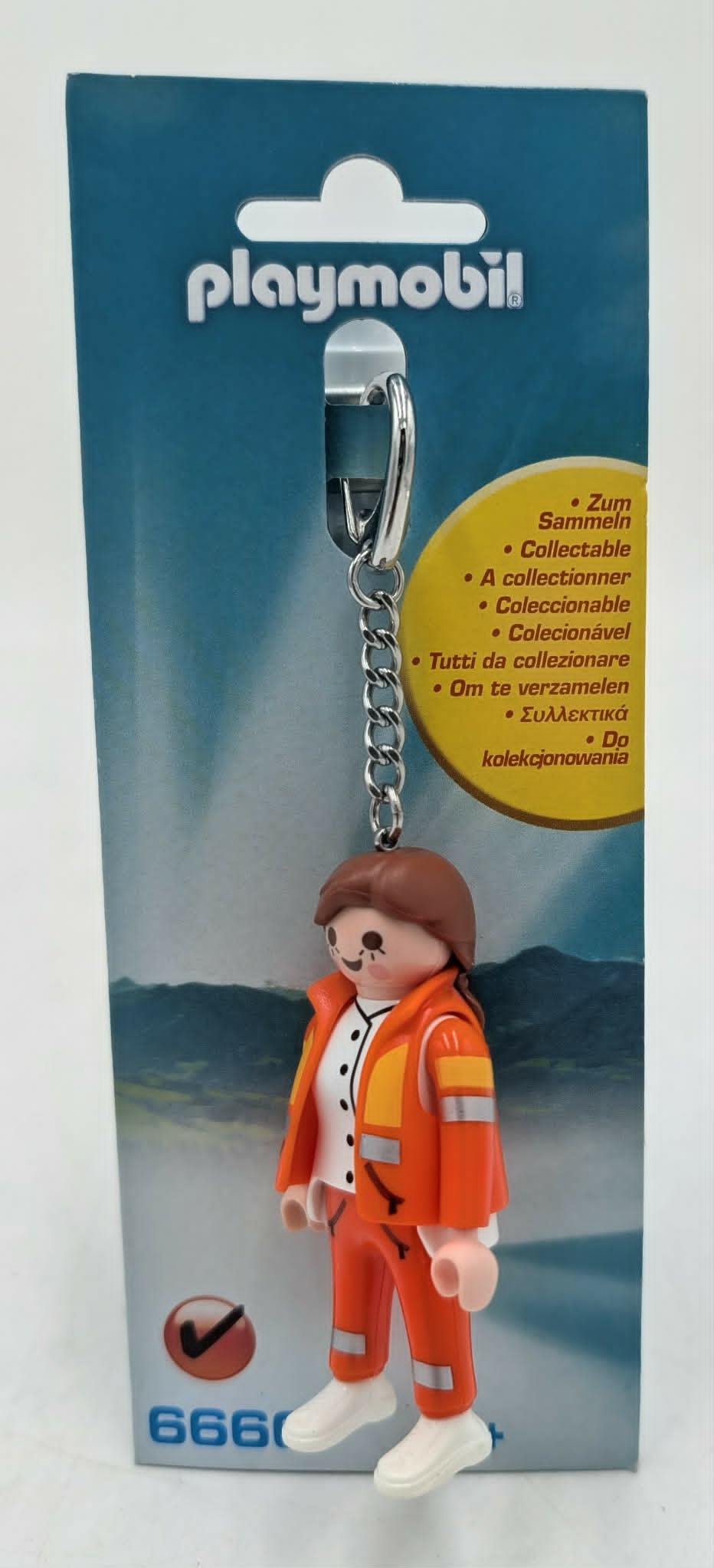 Portachiavi Playmobil: Bambino in abiti da lavoro arancioni su confezione.