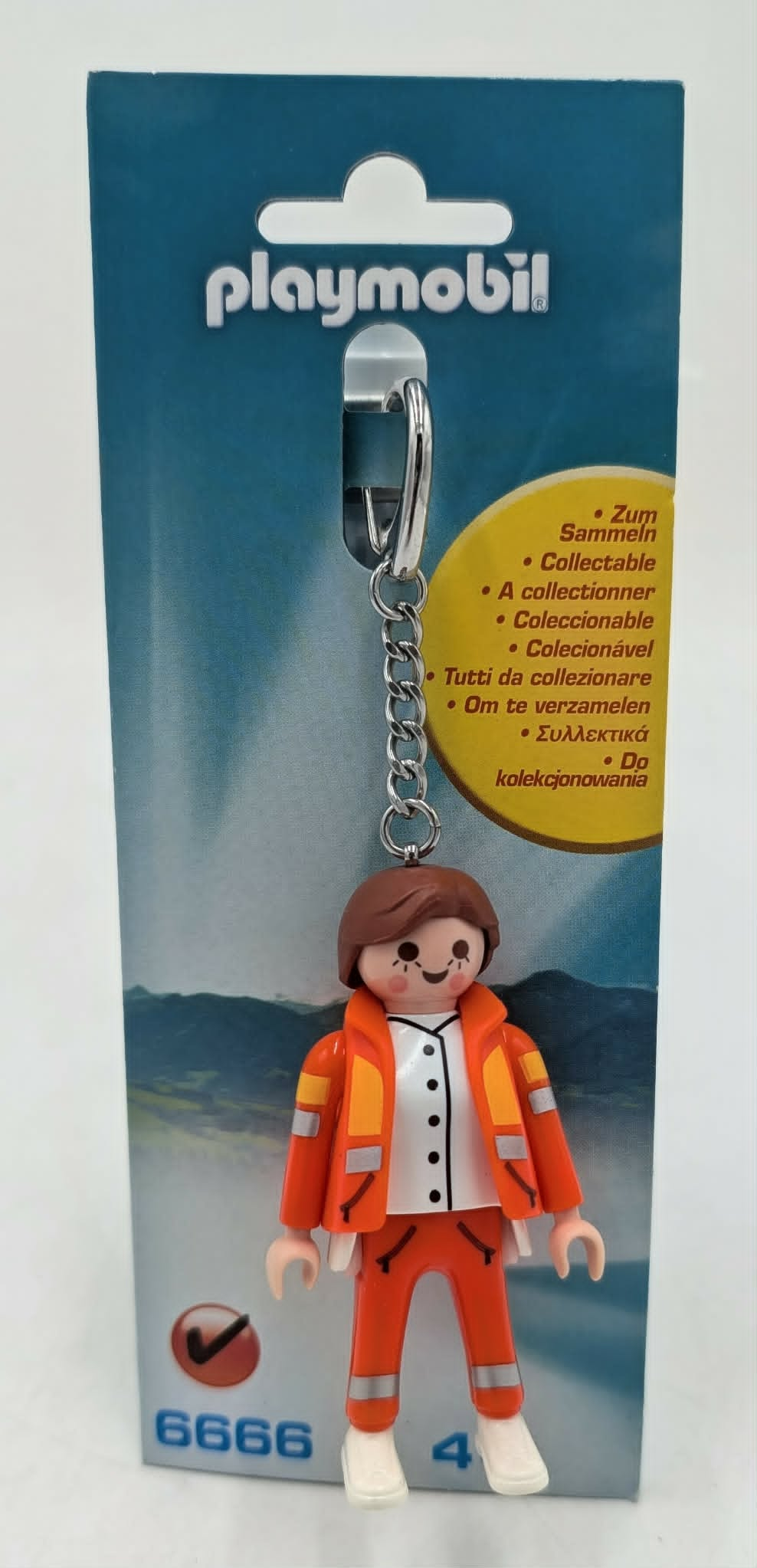 Portachiavi Playmobil con figura in abiti da lavoro arancioni su sfondo blu.