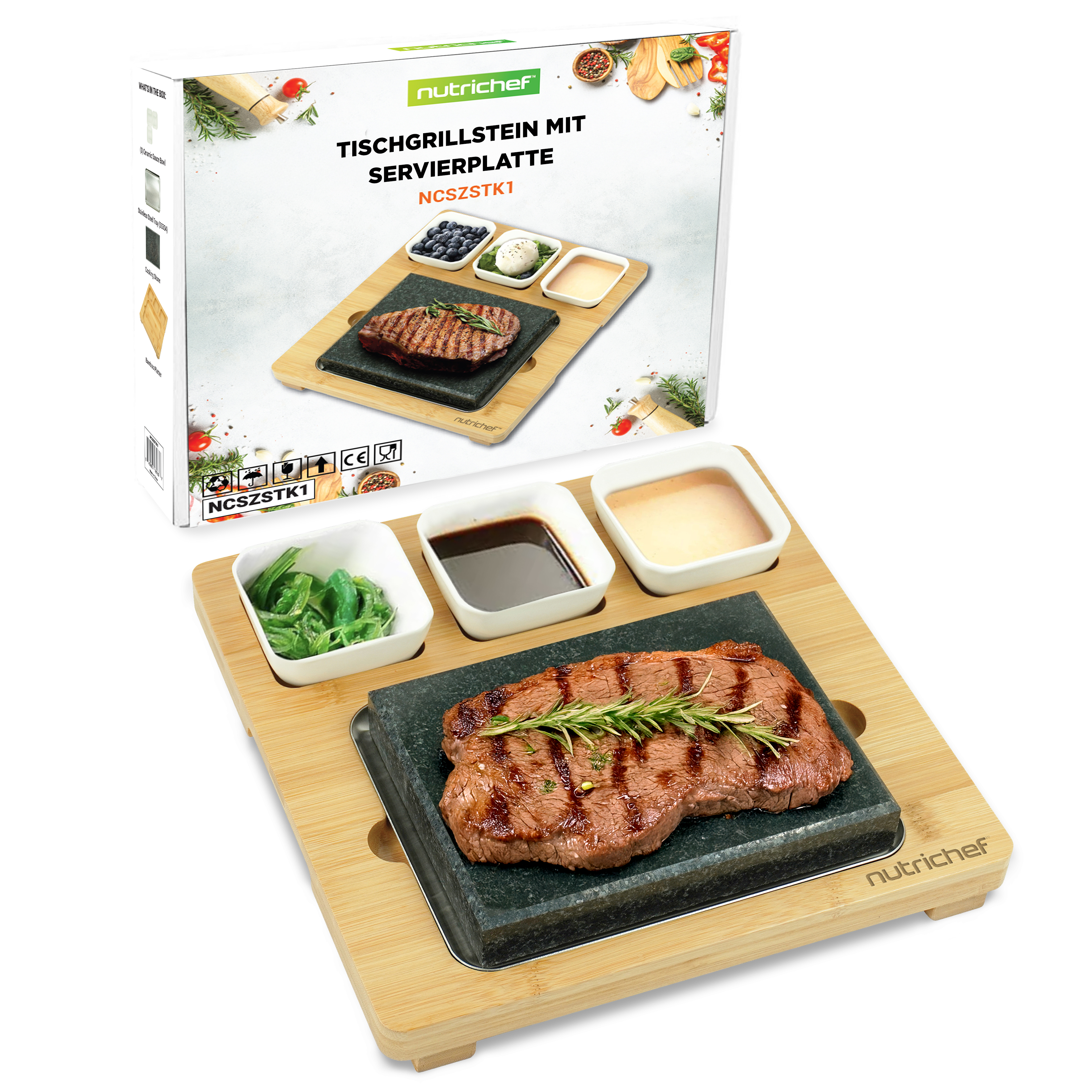 Gegrilltes Steak auf einem Stein mit drei Schalen auf einem Bambustablett.