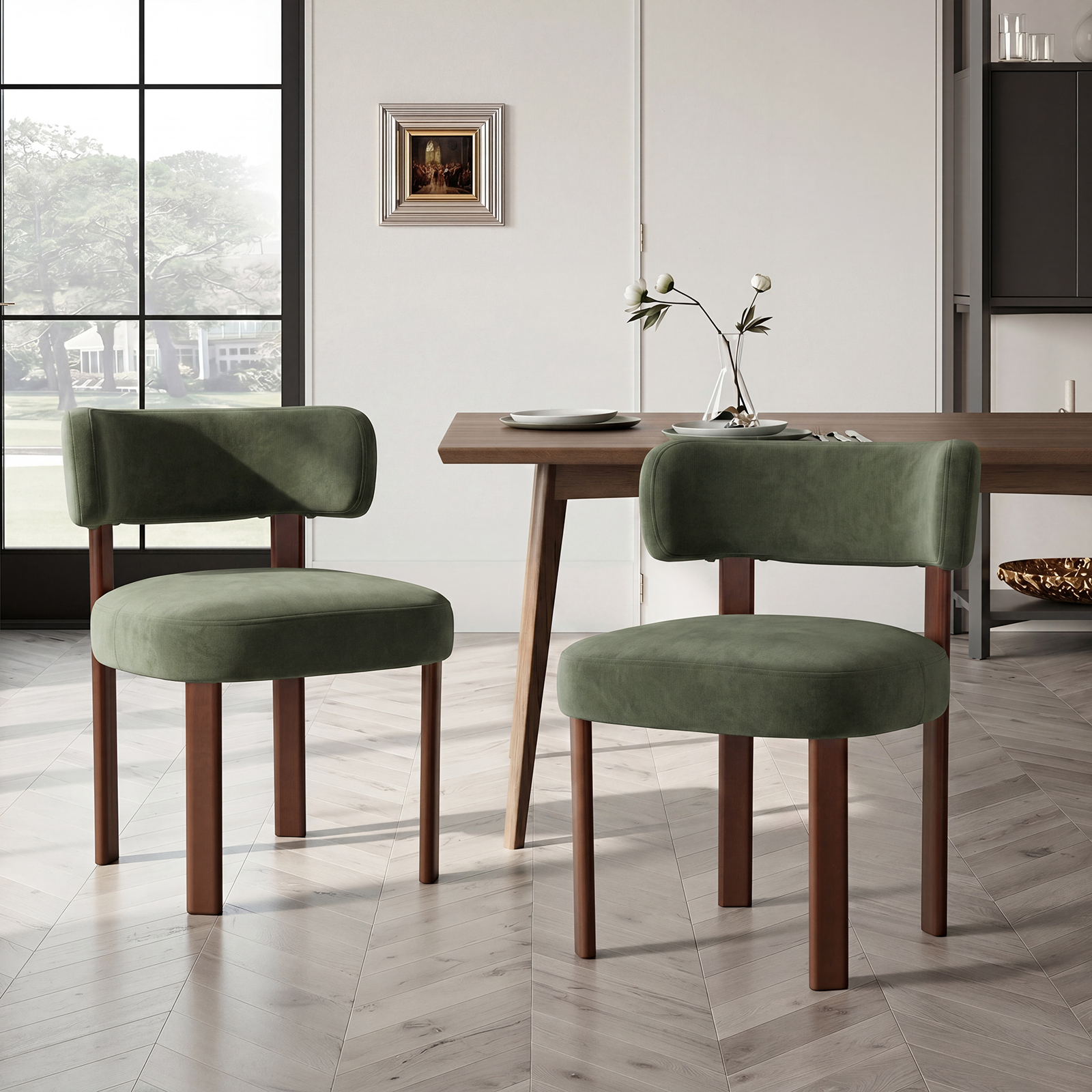 Due sedie verdi con gambe in legno davanti a un tavolo di legno con fiori e piatti.