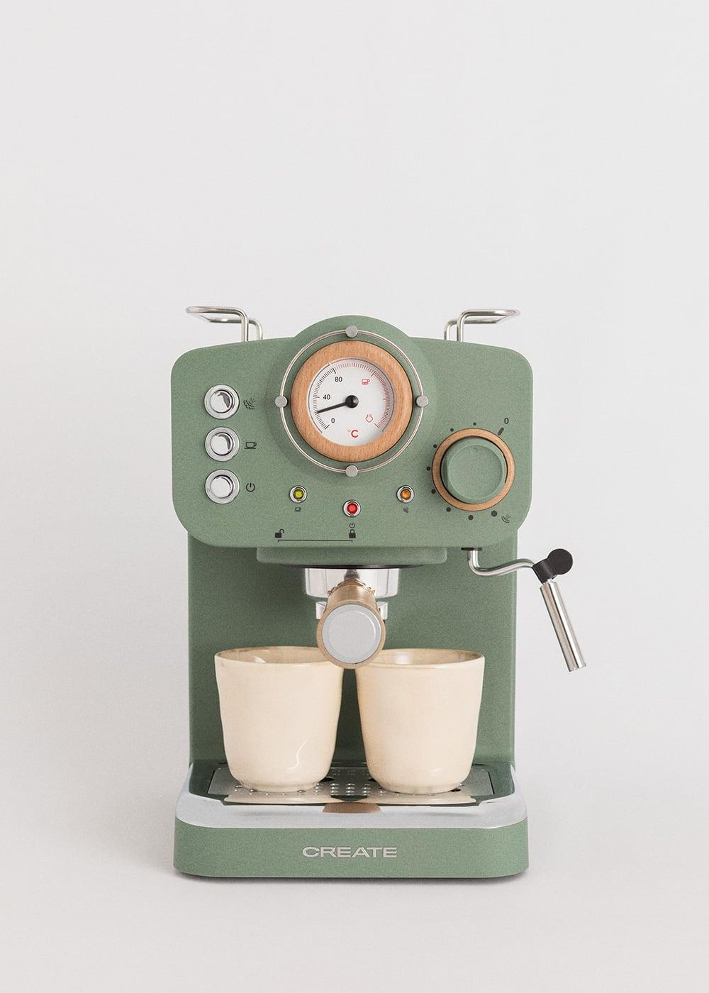 Máquina de espresso verde con dos tazas y un termómetro.