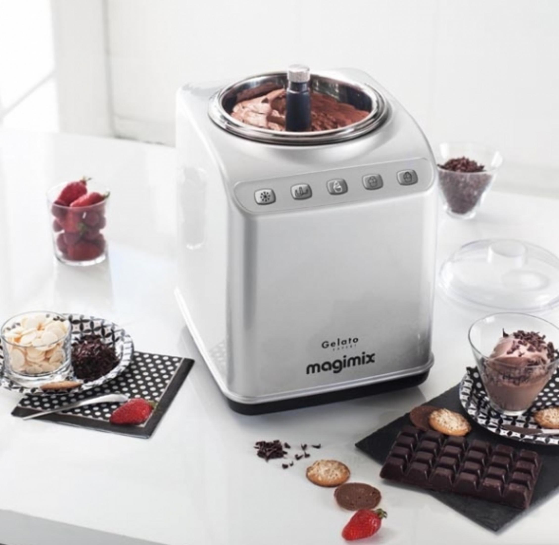 Una gelatiera argentata con gelato al cioccolato, fragole e biscotti.