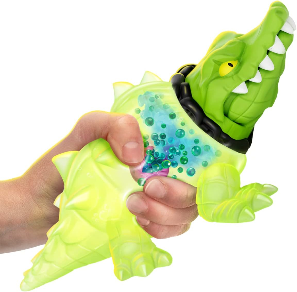 Una mano aprieta un juguete de cocodrilo verde brillante con burbujas dentro.