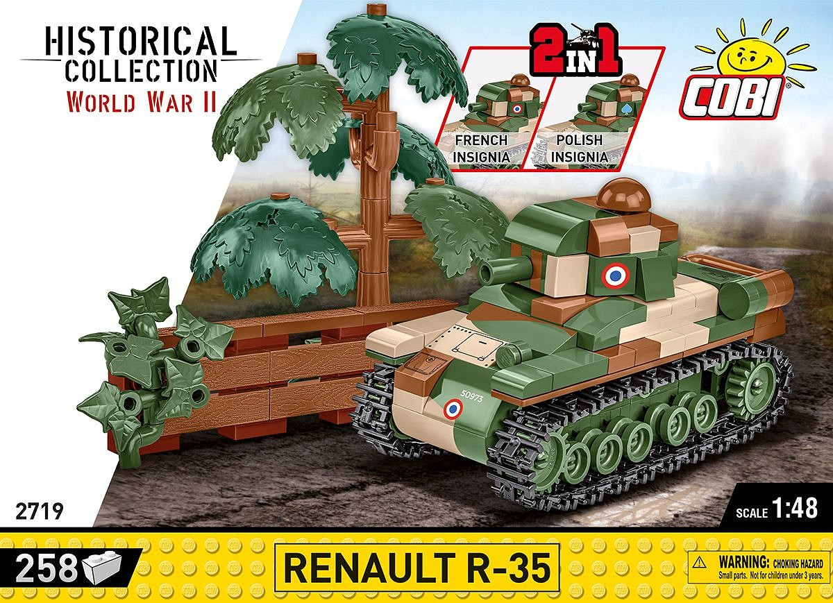 Ein grüner und brauner Spielzeugpanzer mit französischen oder polnischen Abzeichen, Bäumen und Holz.
