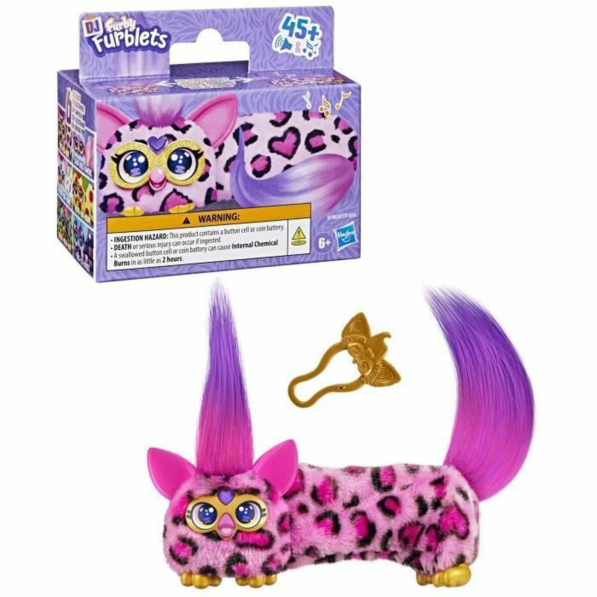Ein pinker Furby mit Leopardenmuster und lila Haaren, daneben die Verpackung.