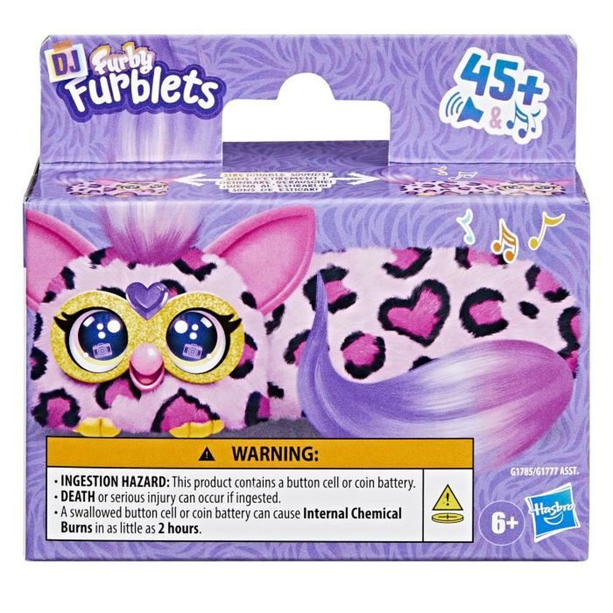 Verpackung eines pink-gefleckten Furby-Spielzeugs mit Warnhinweisen und Altersangabe.